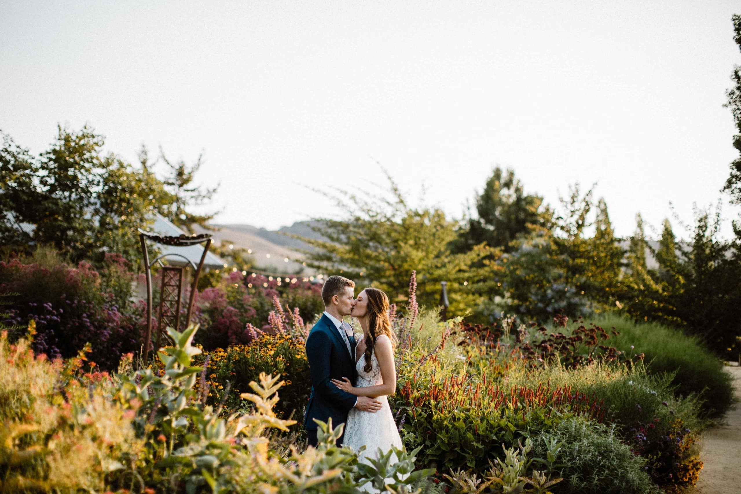 SBHG Bride and groom kissing in the middle of a garden scaled
